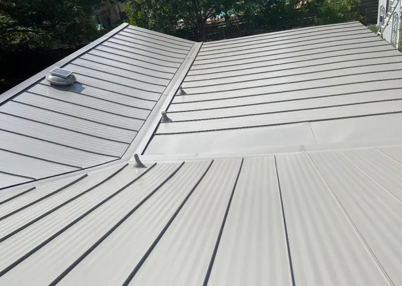 Solar attic fan installed on a metal roof for Roof Ventilation in Monroe